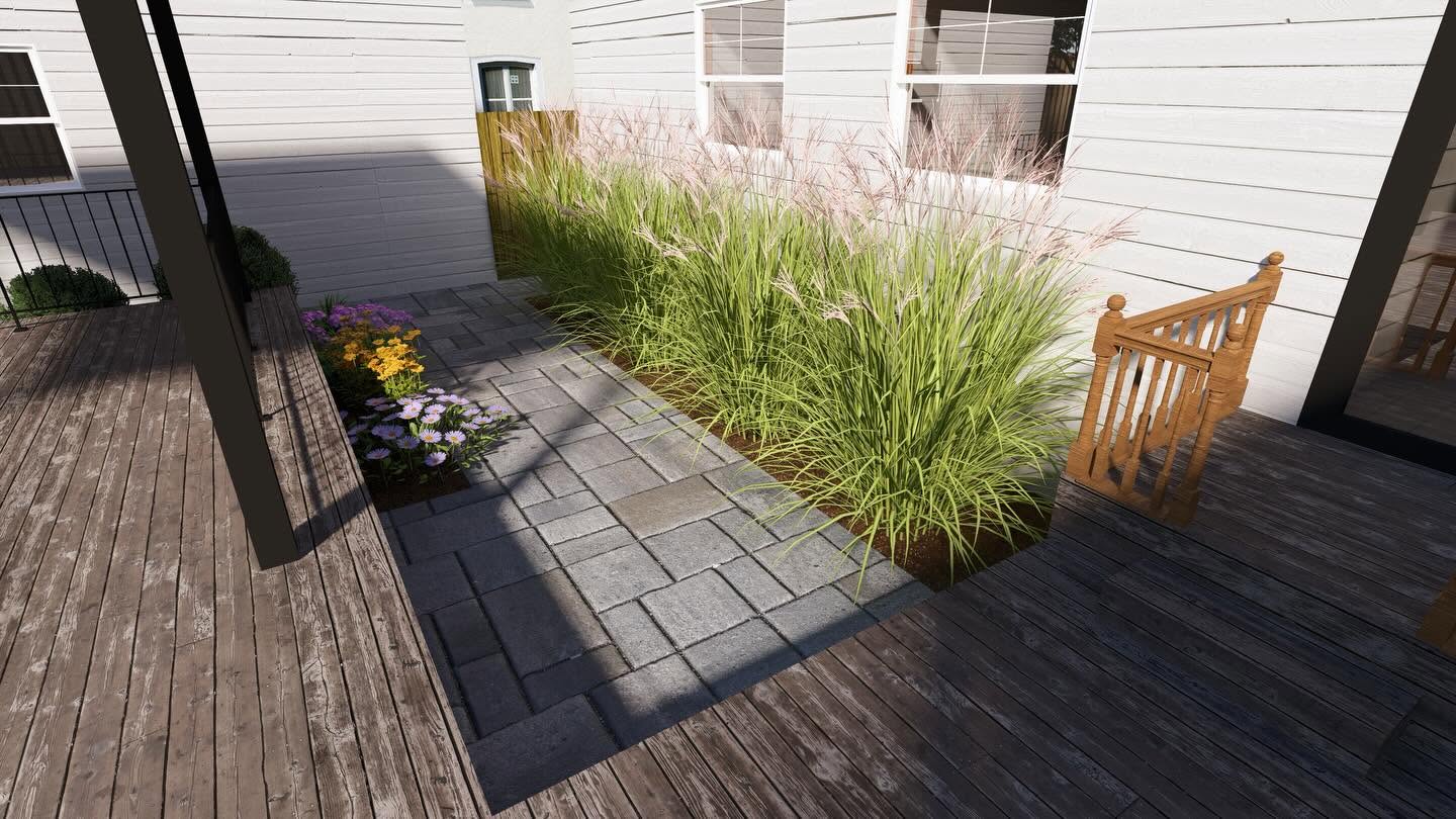 Paver inlay with ornamental grasses and seasonal flowers beside the deck